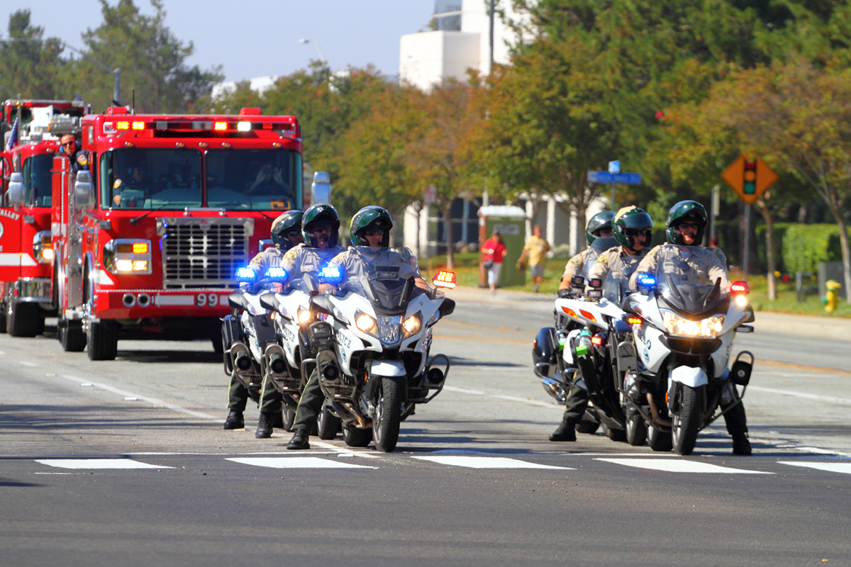 Police escort down a Moreno Valley Street.